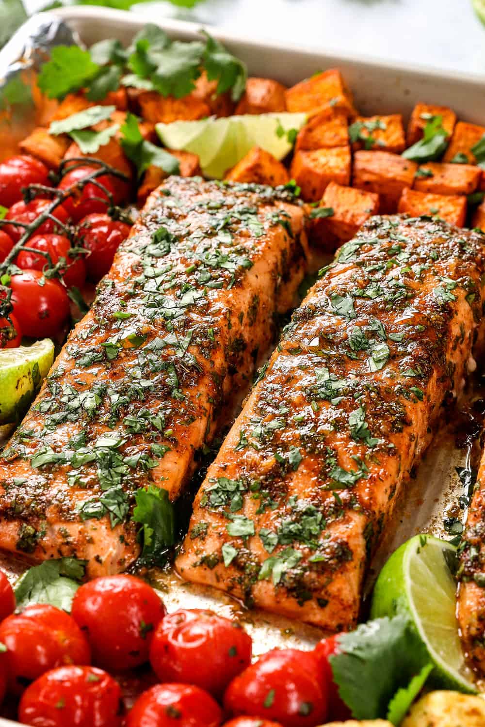up close of baked salmon fillets on a baking sheet
