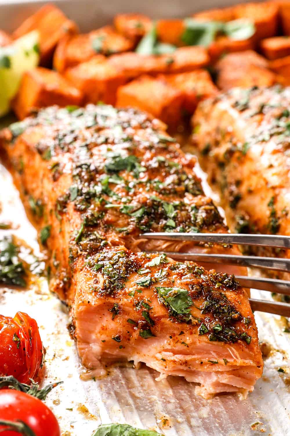 up close showing how tender baked marinated salmon is by flaking with a fork