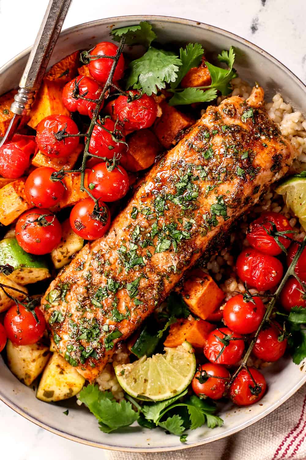 showing how to serve baked cilantro lime salmon with veggies