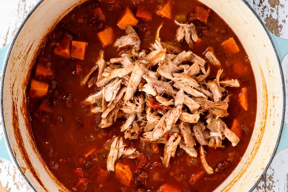 showing how to make easy chicken chili recipe by adding shredded chicken back to the finished soup
