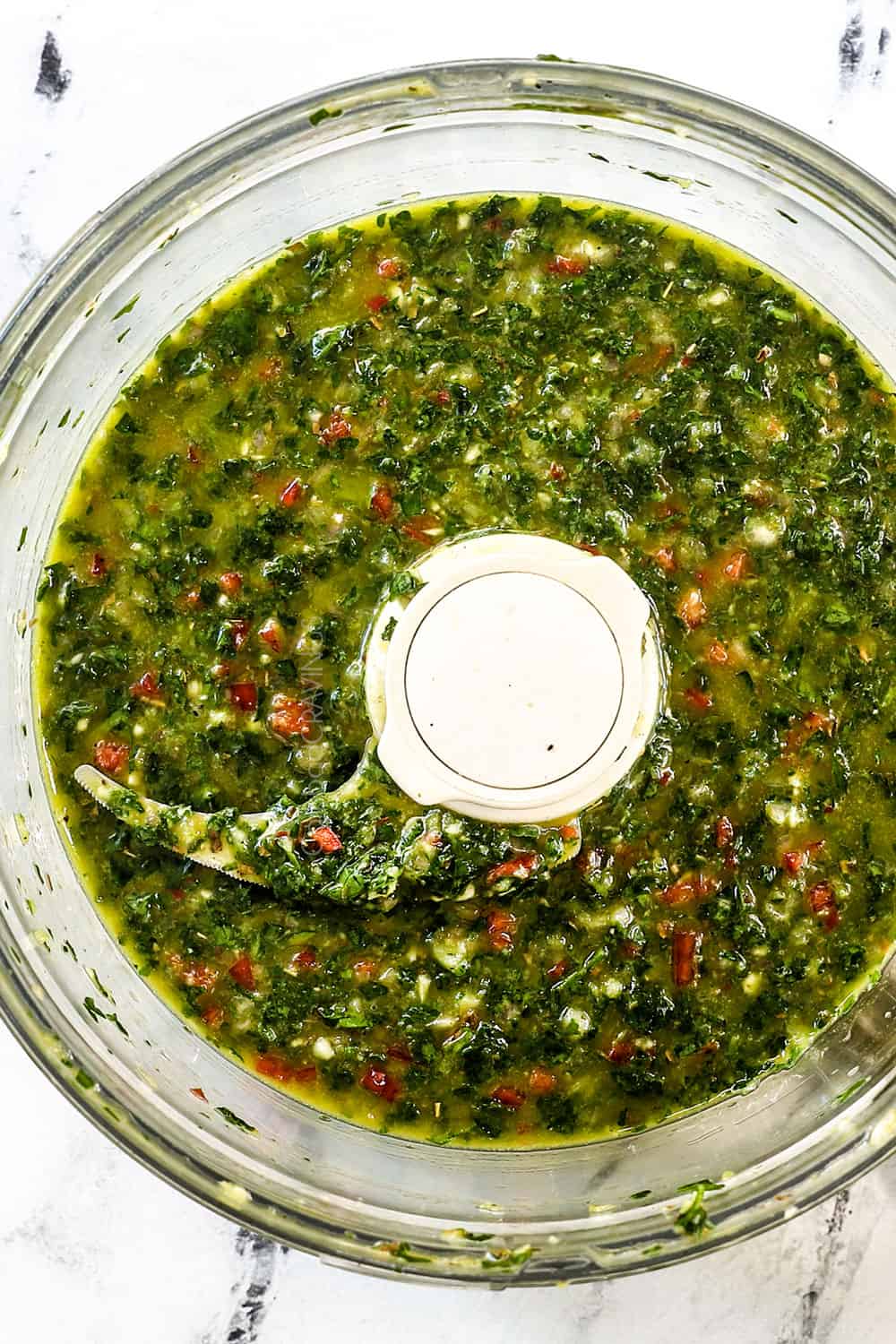 showing how to make best chimichurri sauce by blending in a food processor