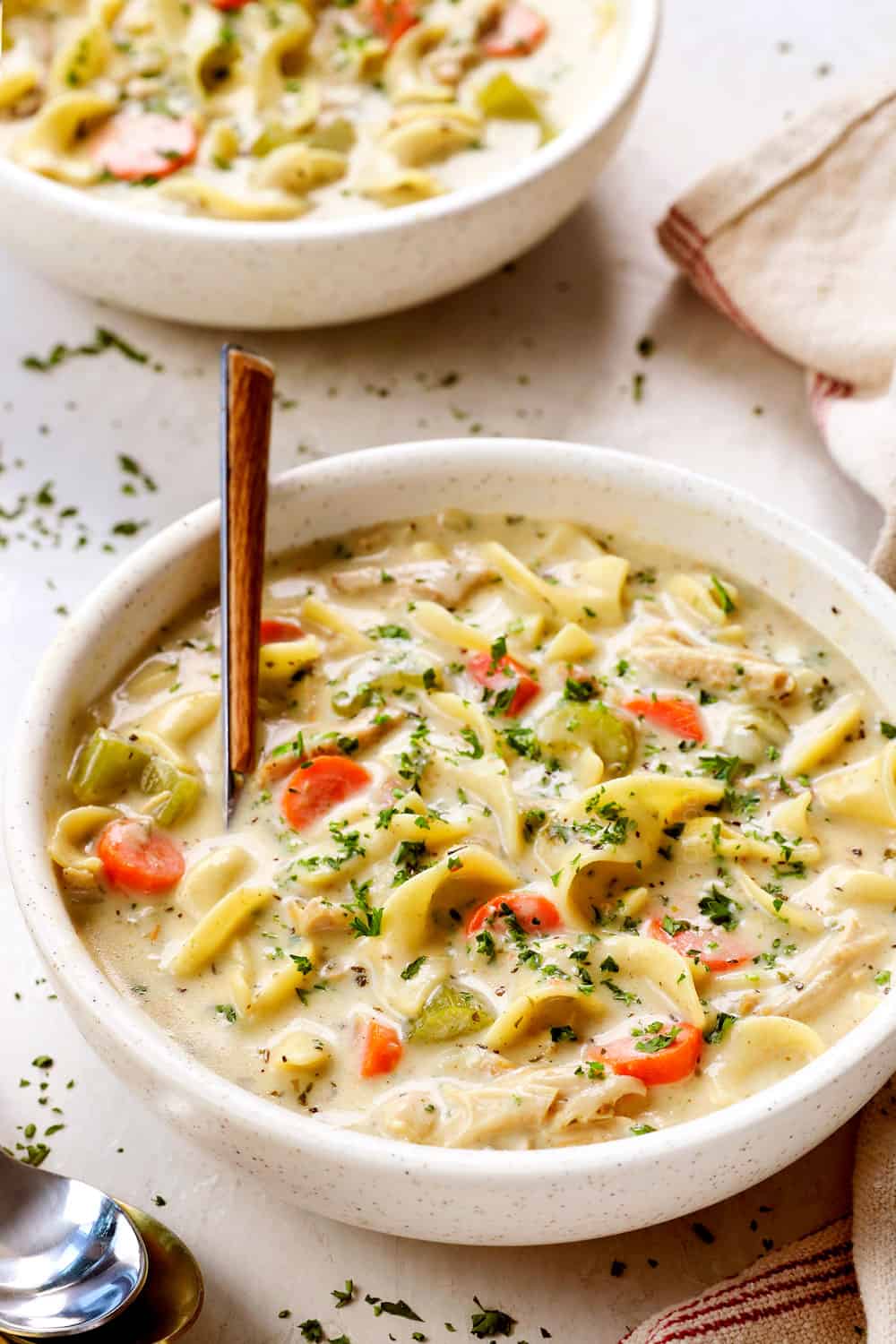 a bowl of homemade creamy chicken noodle soup recipe with egg noodles