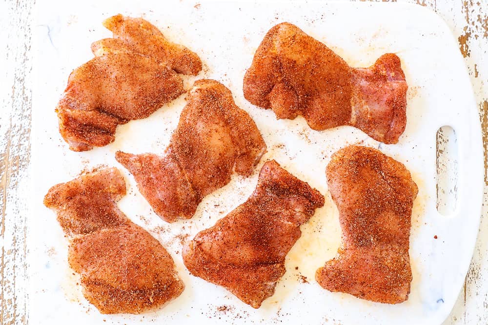 showing how to make honey lime chicken by seasoning chicken with a spice rub