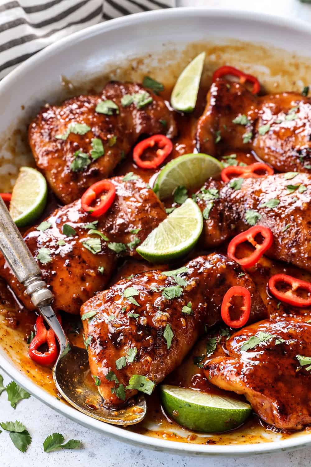 honey lime chicken made with thighs in a skillet with sticky sauce