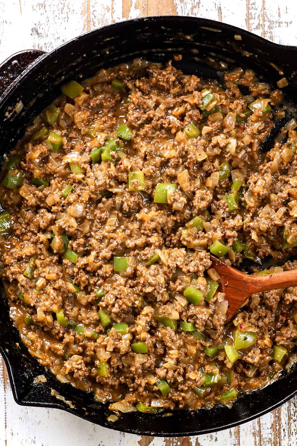 showing how to make Philly Cheesesteak Sloppy Joes with top shot of the filling in a skillet showing the correct consistency 