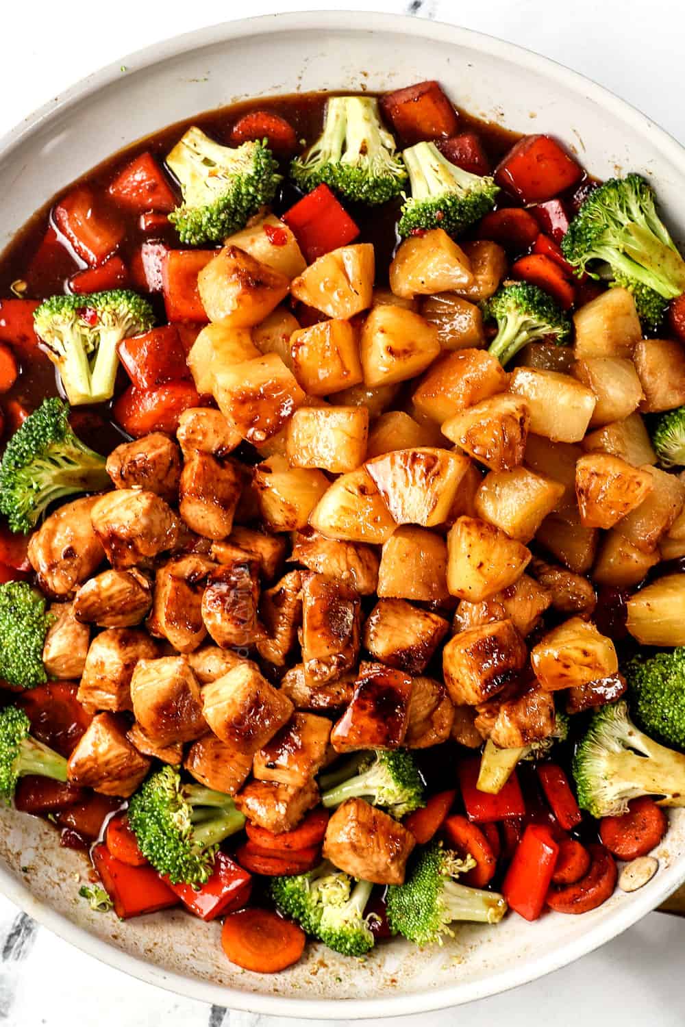 top view of teriyaki chicken stir fry recipe by adding chicken and stir fry sauce to skillet