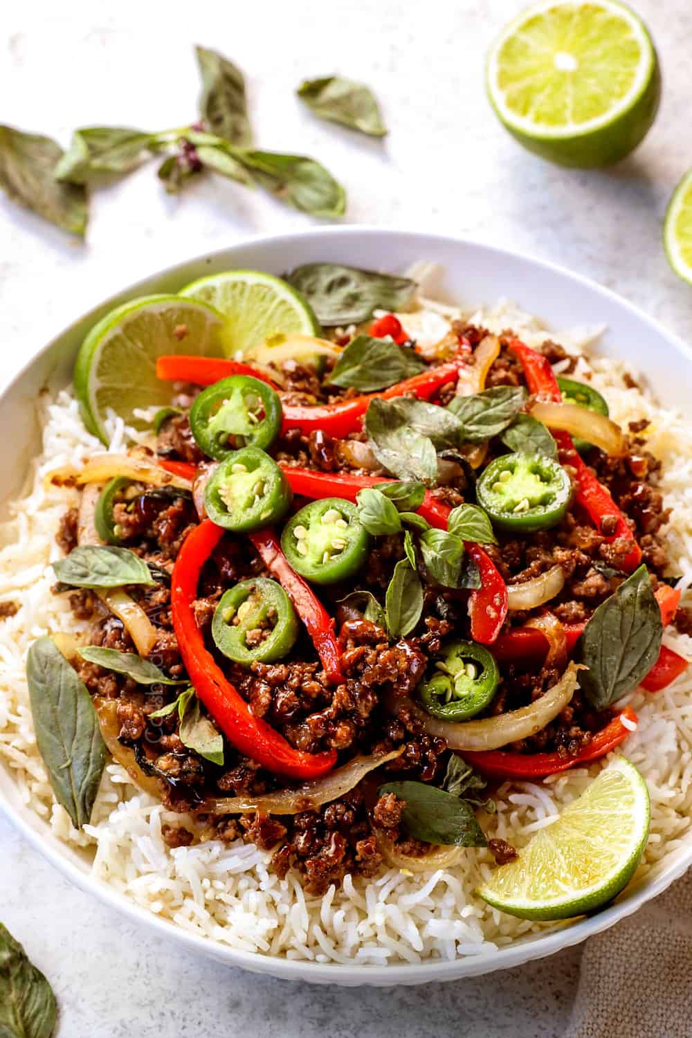 showing how to serve Thai Basil Beef (pad krapow) by serving in a bowl over rice