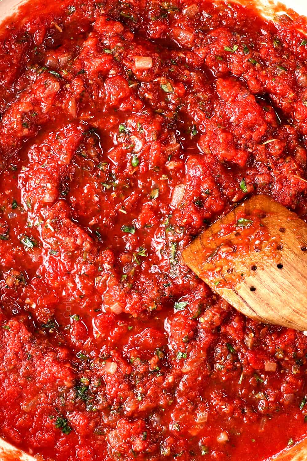 top view of stirring tomato sauce recipe 