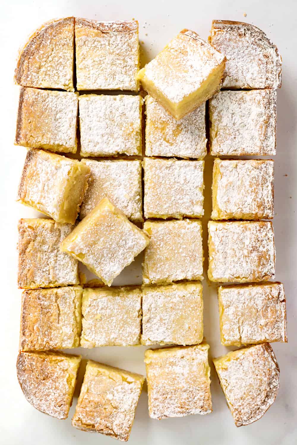 showing how to make Gooey Butter Cake recipe by cutting into squares once cooled