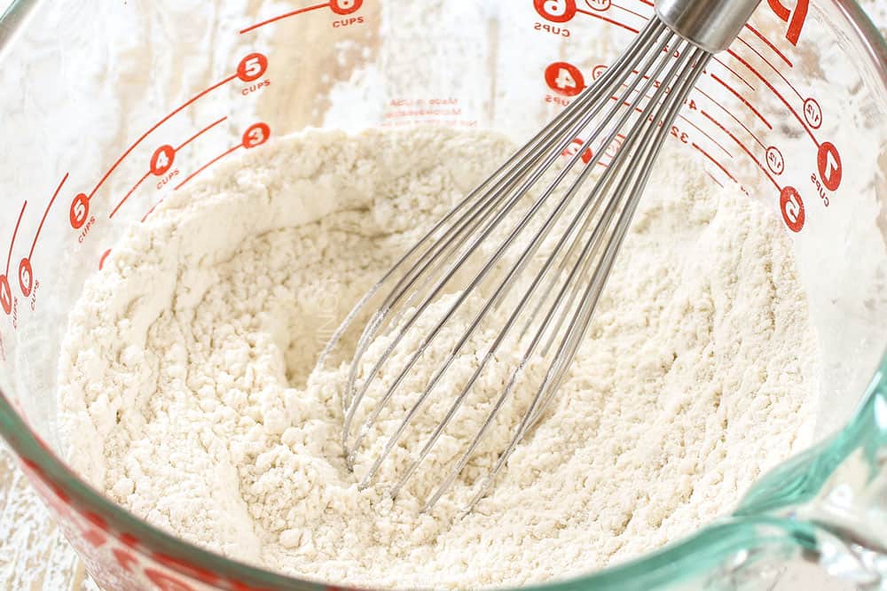showing how to make Ooey Gooey Butter Cake recipe by mixing dry ingredients in a bowl
