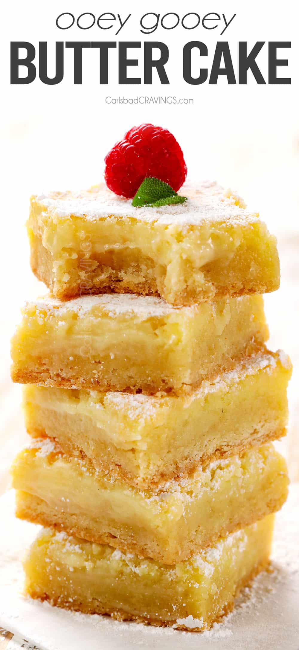 a stack of Gooey Butter Cake recipe with a bite out of one of the squares showing how creamy they are