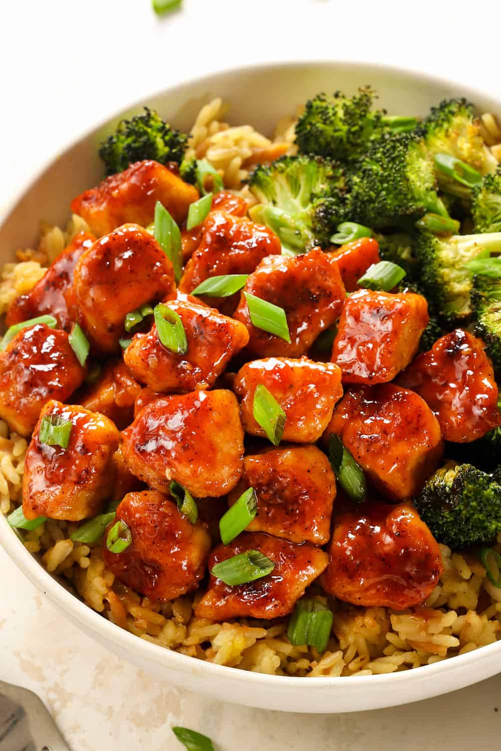 a bowl of apricot chicken with rice and broccoli showing what to serve with the recipe