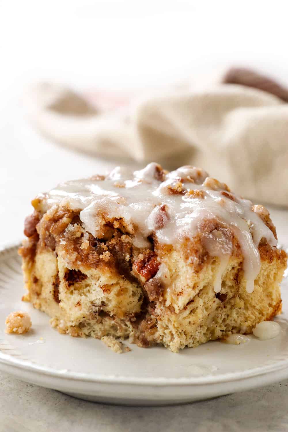a slice of cinnamon roll French toast bake with a bite taken out of it