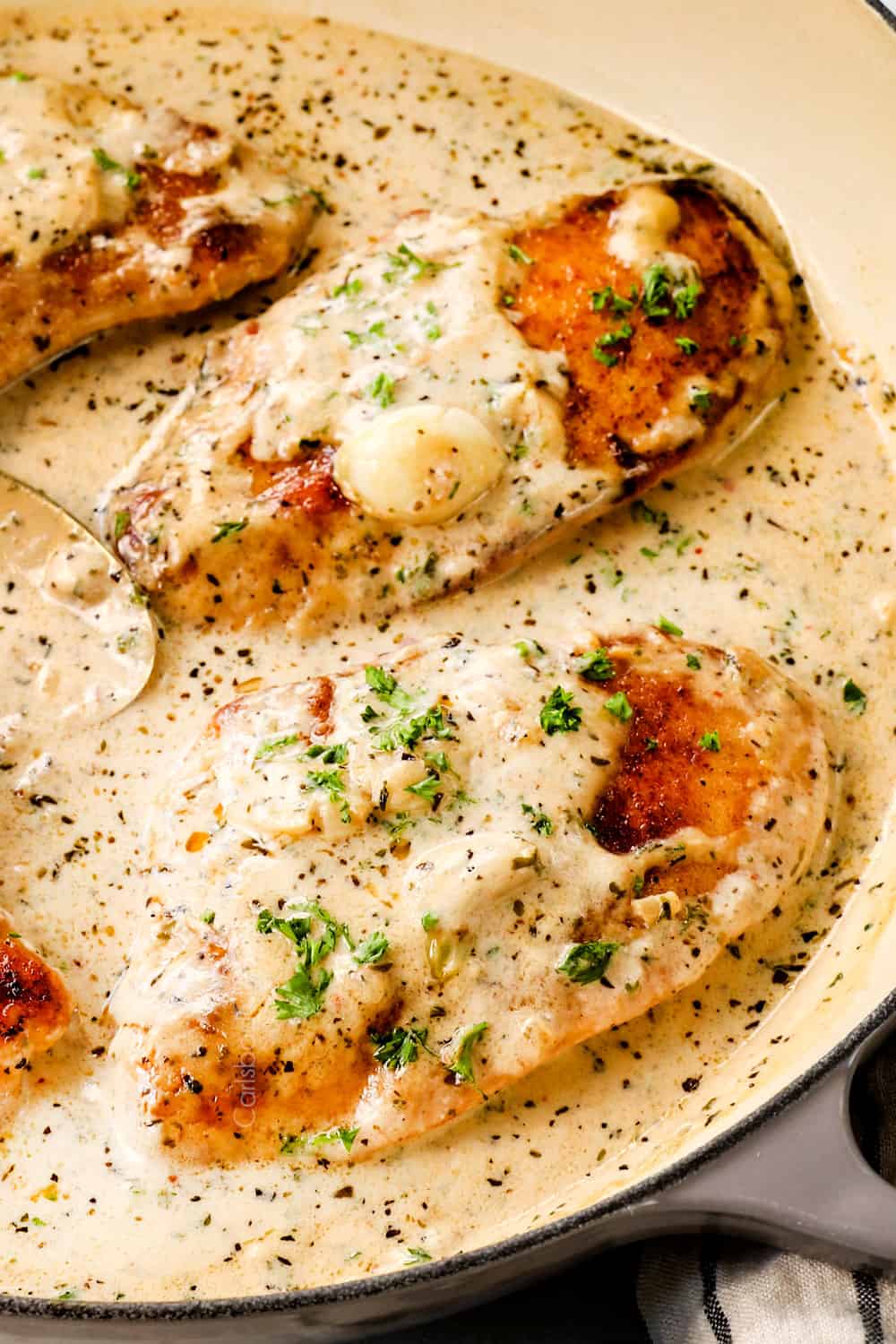 up close of garlic chicken recipe in creamy garlic Parmesan sauce showing how creamy the chicken ise chicken is