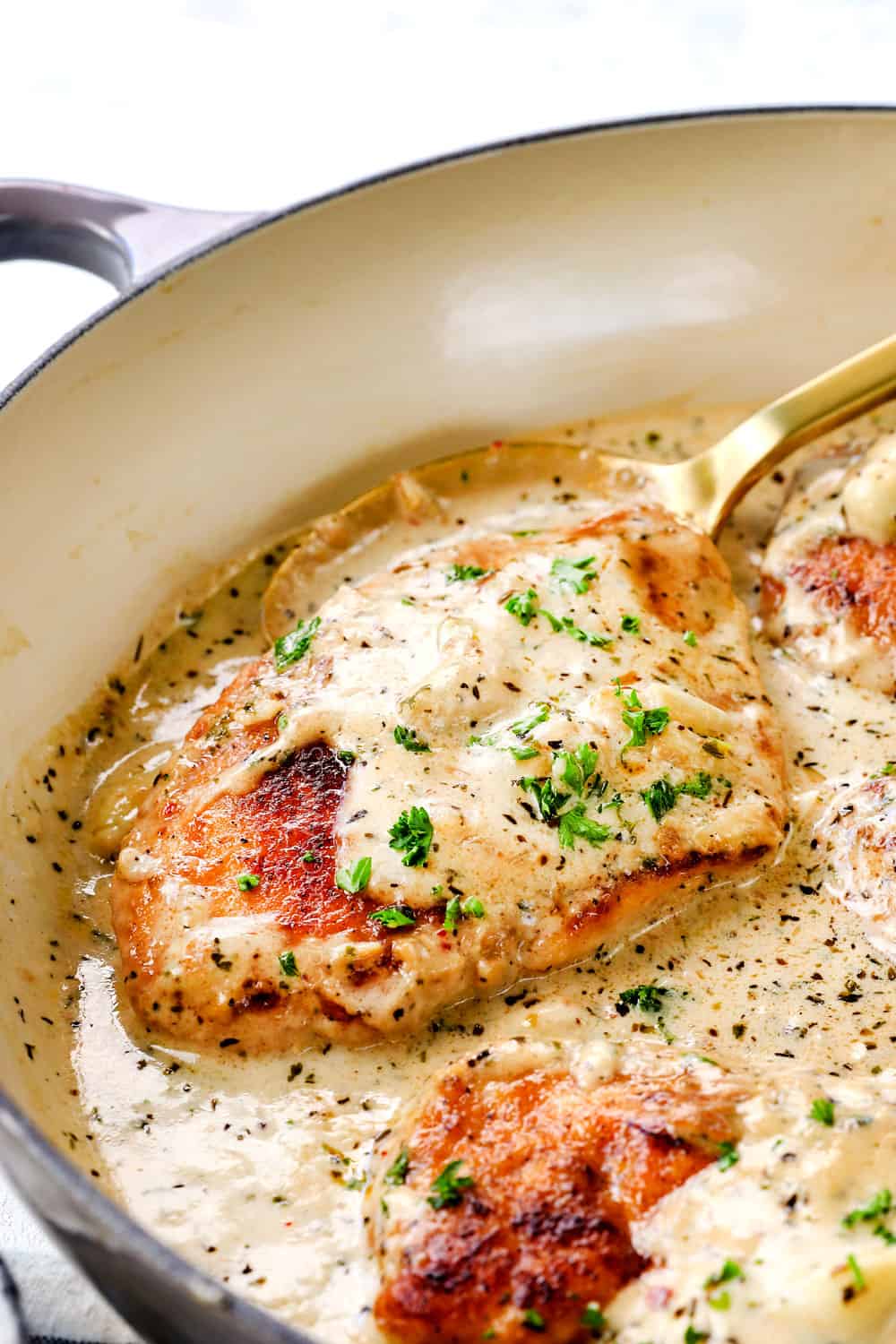 up close of garlic chicken recipe in creamy Parmesan sauce showing how juicy the chicken is