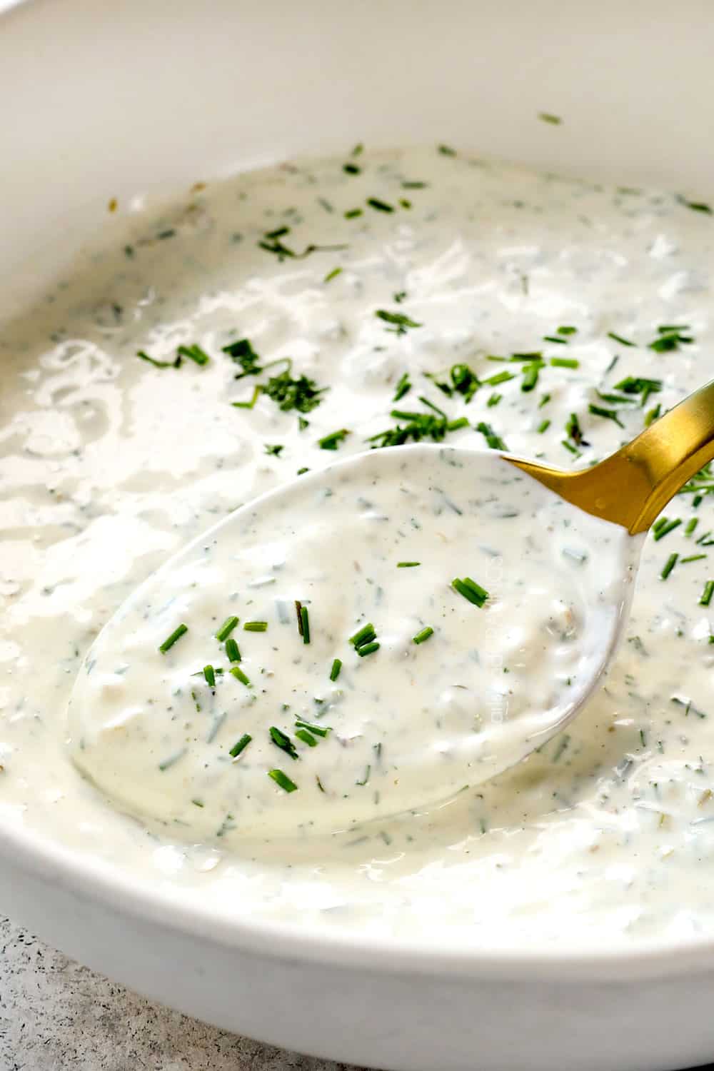 showing what to serve with tartar sauce with an up close of a spoon in tartar sauce