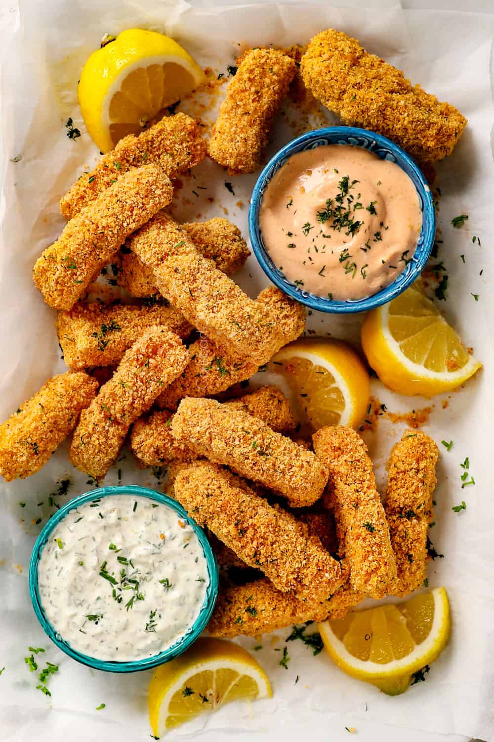 top view of crispy baked fish sticks on a platter