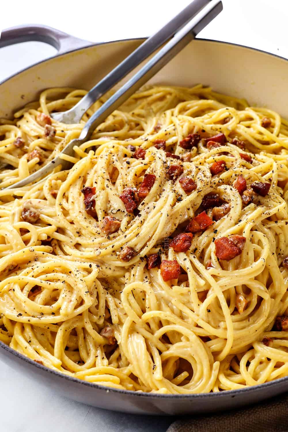 spaghetti carbonara tossed with guanciale, pancetta and bacon