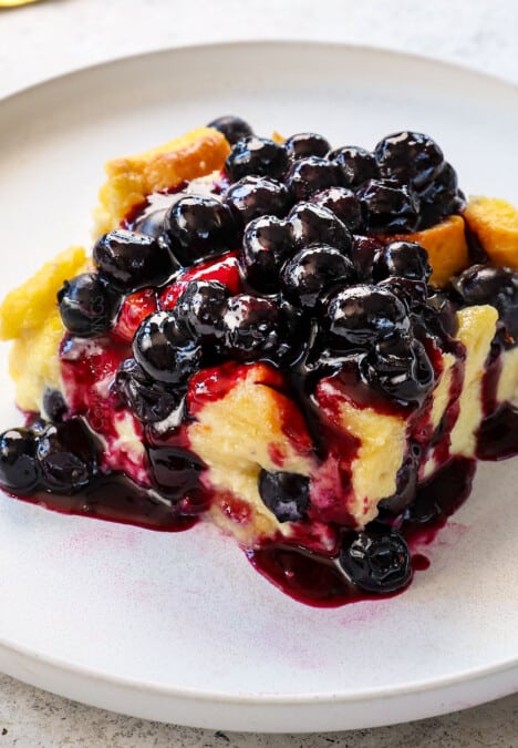 up close of a slice of French toast casserole with blueberry sauce