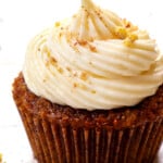 up close of carrot cake cupcake with cream cheese frosting