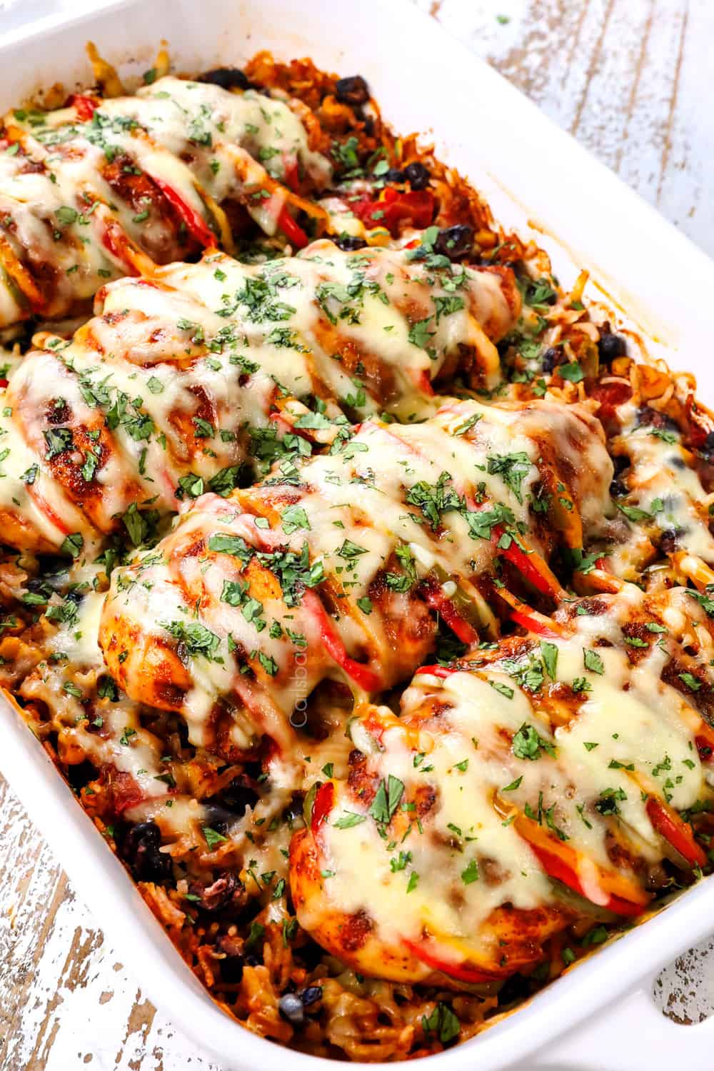 Hasselback chicken with fajita bell peppers baked in a casserole dish