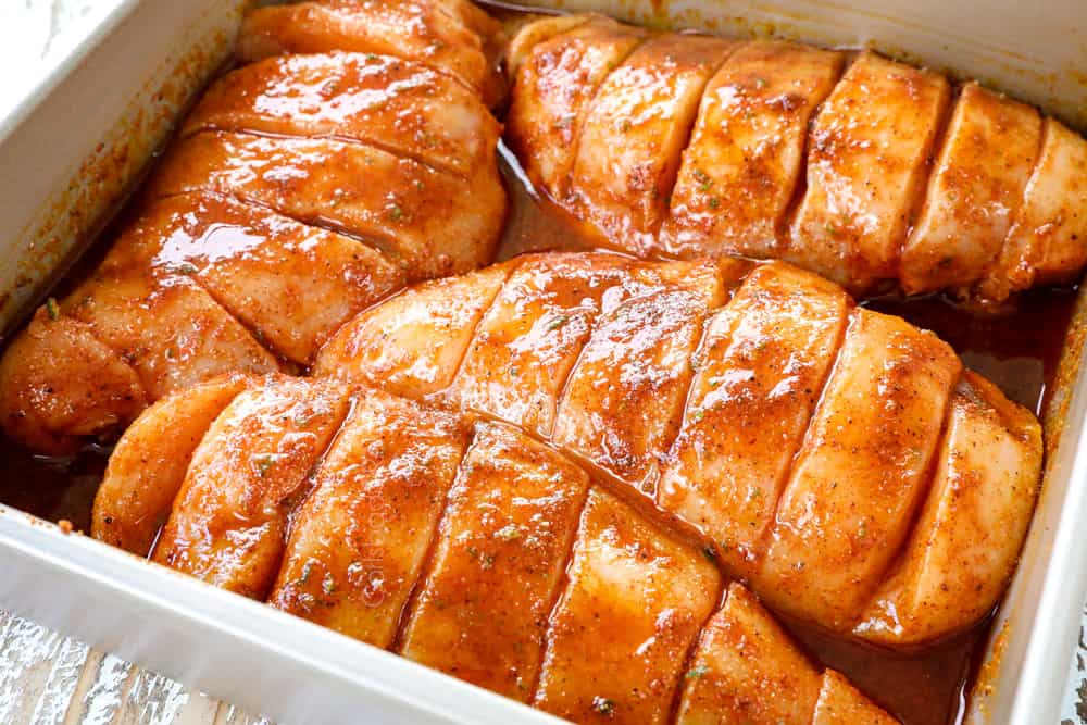 showing how to make Hasselback Chicken by marinating chicken before stuffing