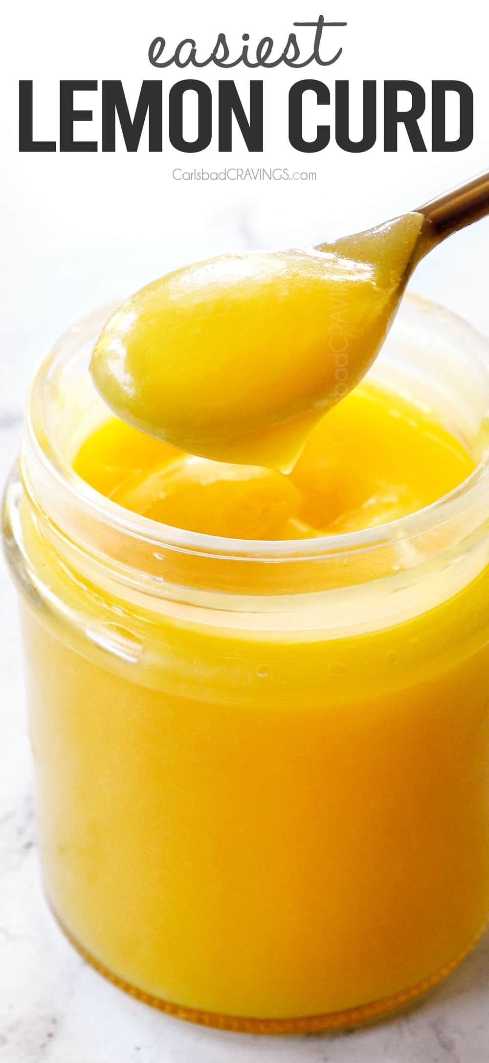 dipping a spoon into lemon curd showing how thick and creamy it is