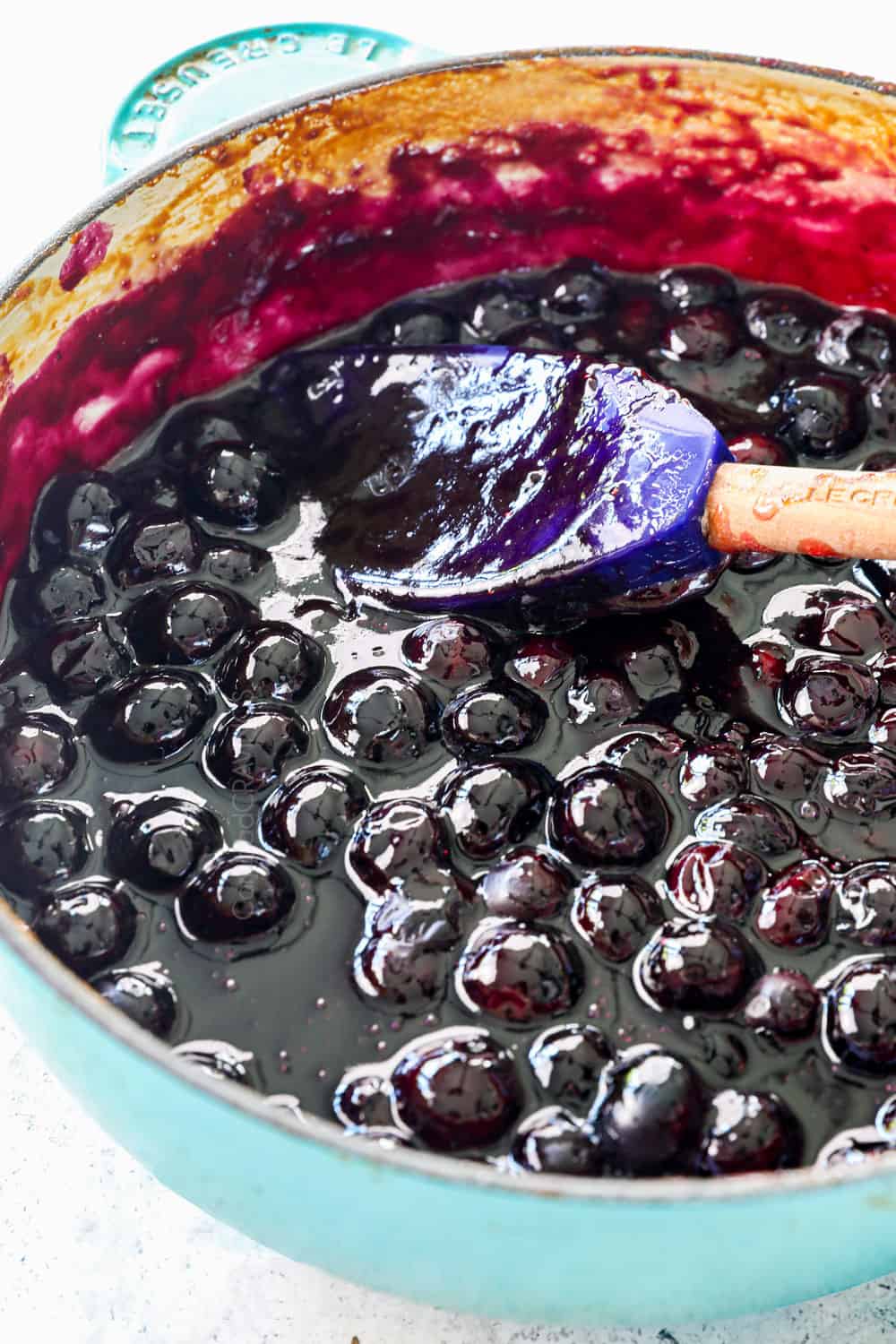 up close of blueberry sauce (blueberry syrup) in a saucepan showing the consistency