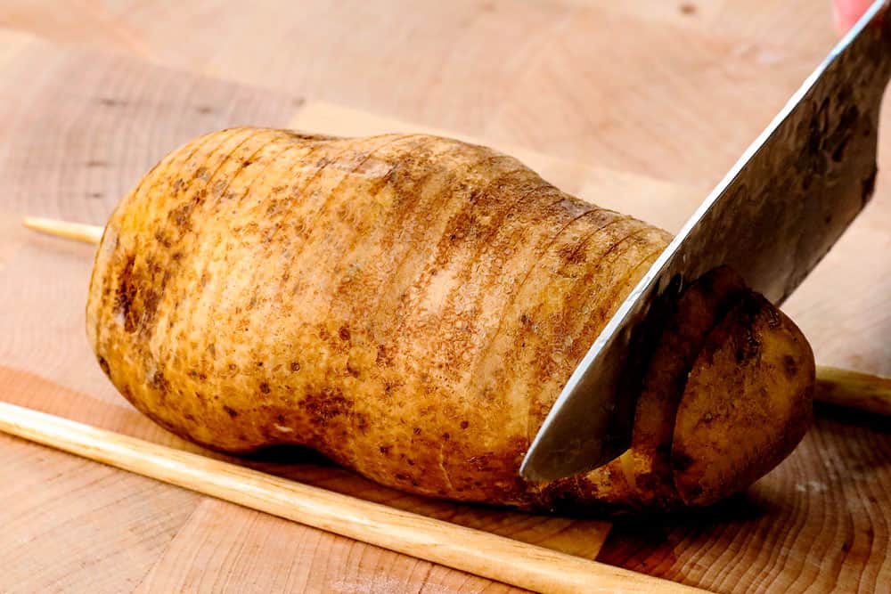 showing how to make Hasselback potatoes by slicing potatoes into 1/8th inch slices