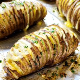 showing how to make Hasselback potato recipe by baking potatoes by garnishing with chives
