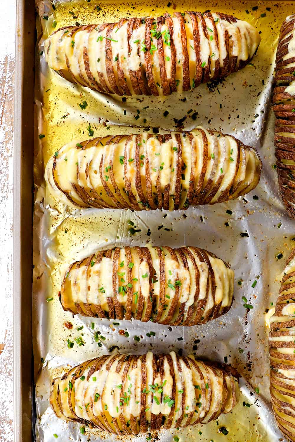 top view of showing how to make Hasselback potatoes baked with cheese until melted