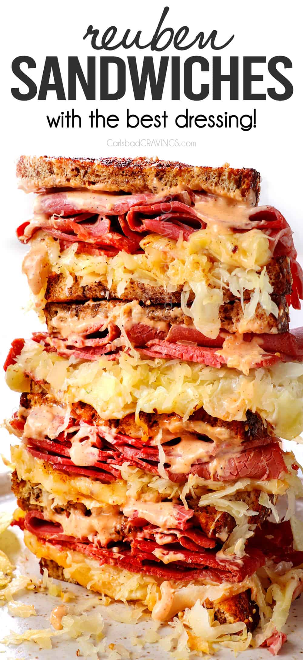 a stack of Reuben Sandwich slices with Russian dressing, corned beef, Swiss cheese and coleslaw on rye bread