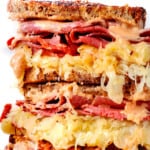 up close of Reuben sandwich sliced and stacked showing how cheesy it is