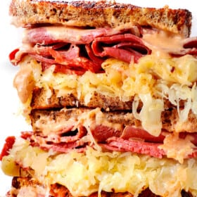up close of Reuben sandwich sliced and stacked showing how cheesy it is