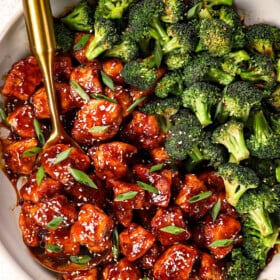 top view of sesame chicken recipe in a skillet with stir fried broccoli