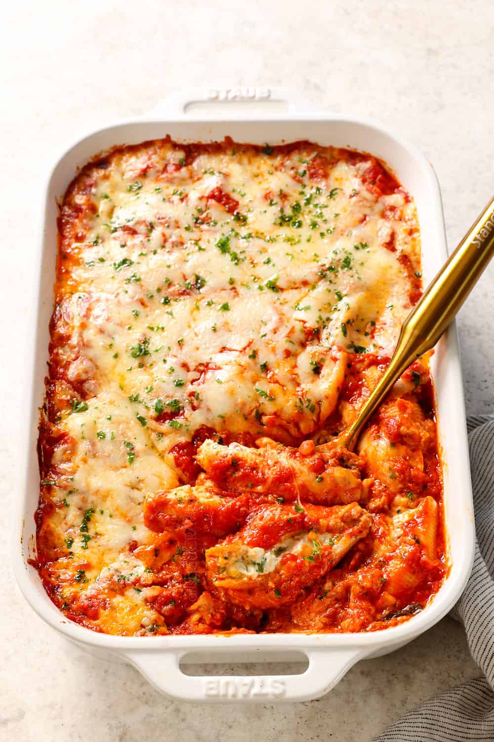 a baking dish recipe of stuffed shells with meat in a baking dish