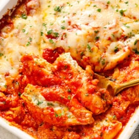 scooping up stuffed shells with meat showing how meaty and cheesy it is