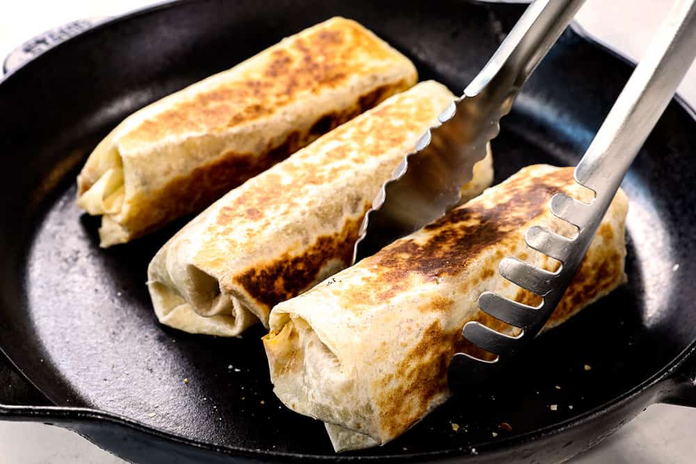 showing how to make beef burrito recipe by toasting burritos in a skillet