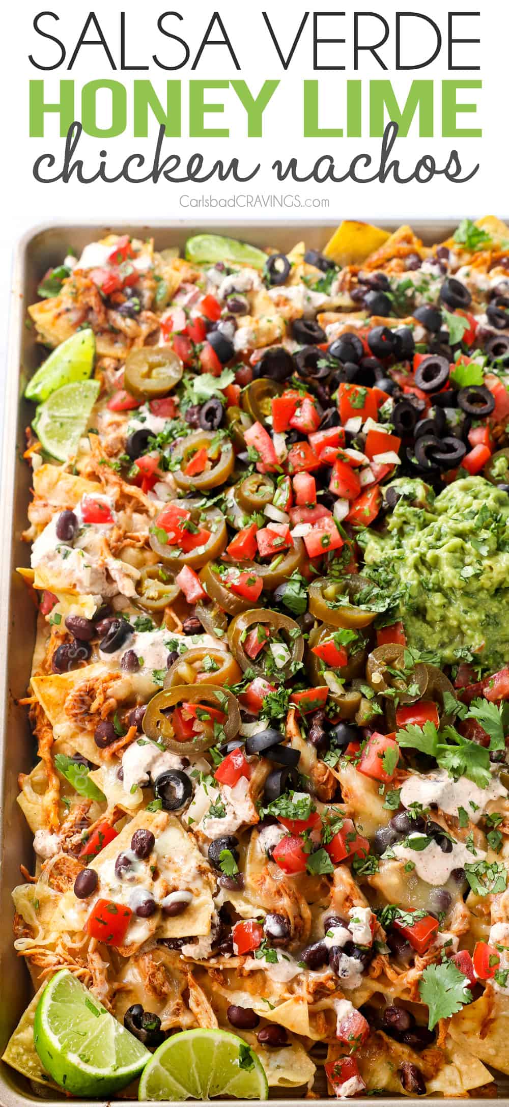 chicken nachos baked in the oven with shredded chicken, cheese and beans then topped with guacamole, sour cream, pico de gallo, olives and jalapenos