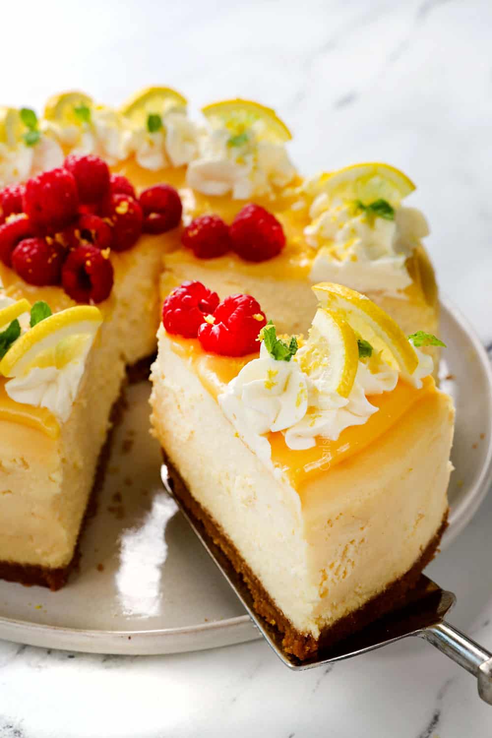 serving a slice of lemon cheesecake with lemon curd