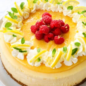 Lemon cheesecake on a white plate with lemon curd topping