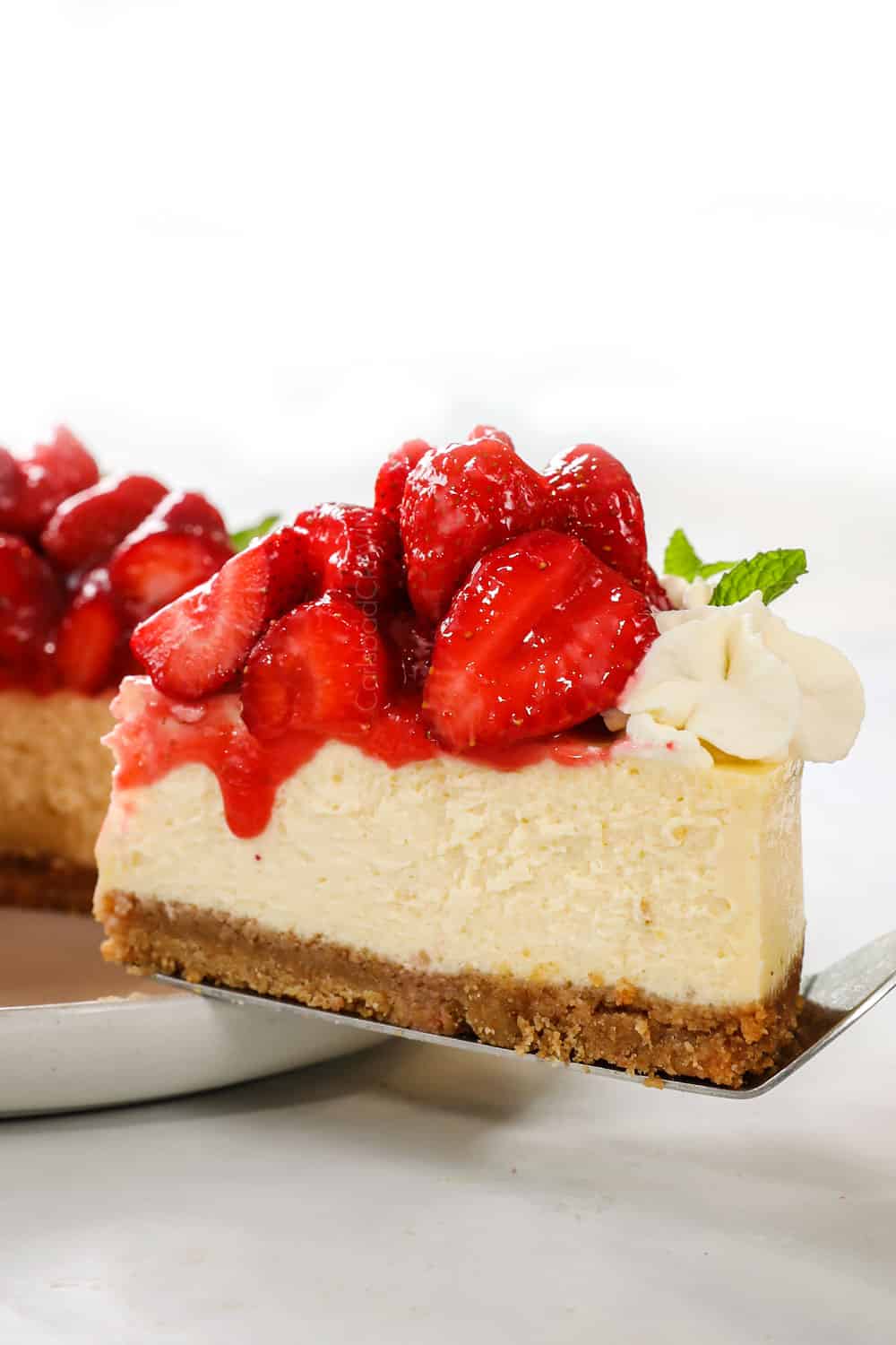 a slice of strawberry cheesecake recipe being served