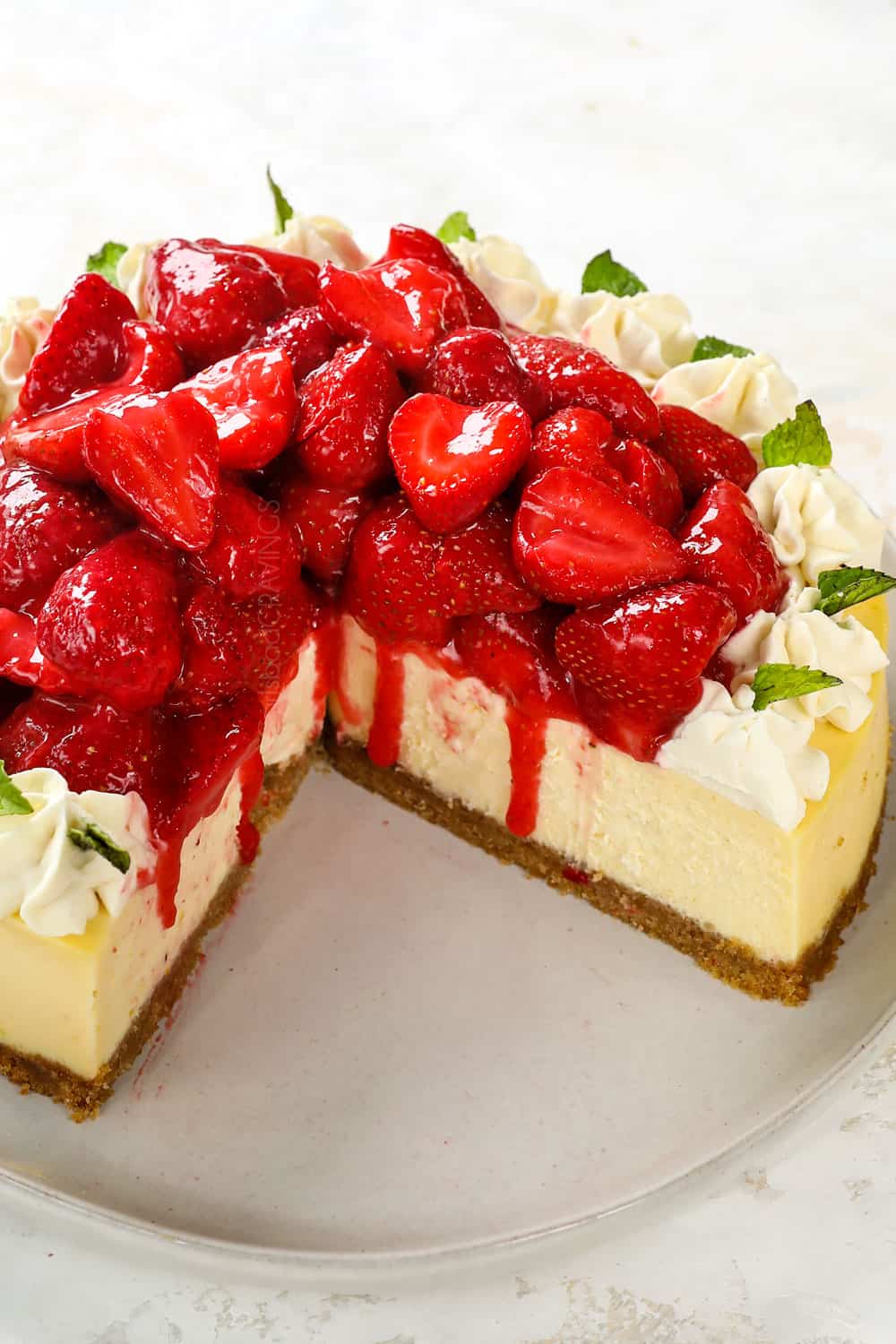 strawberry cheesecake with slices missing showing how creamy it is