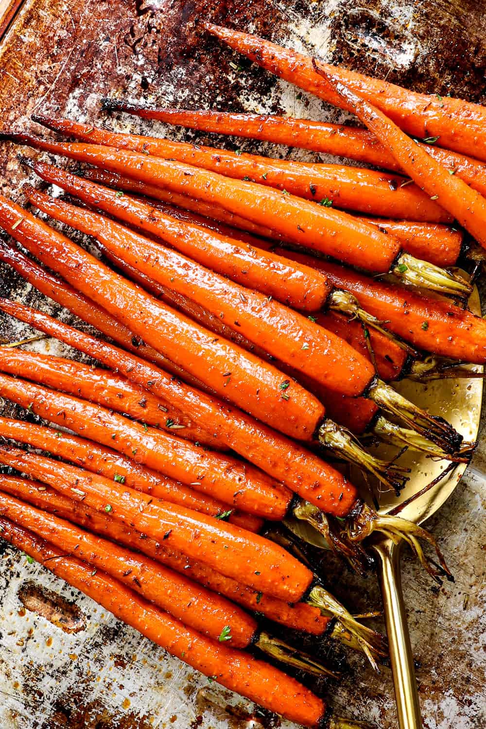 roasted carrot recipe made with young thin carrots on a baking sheet