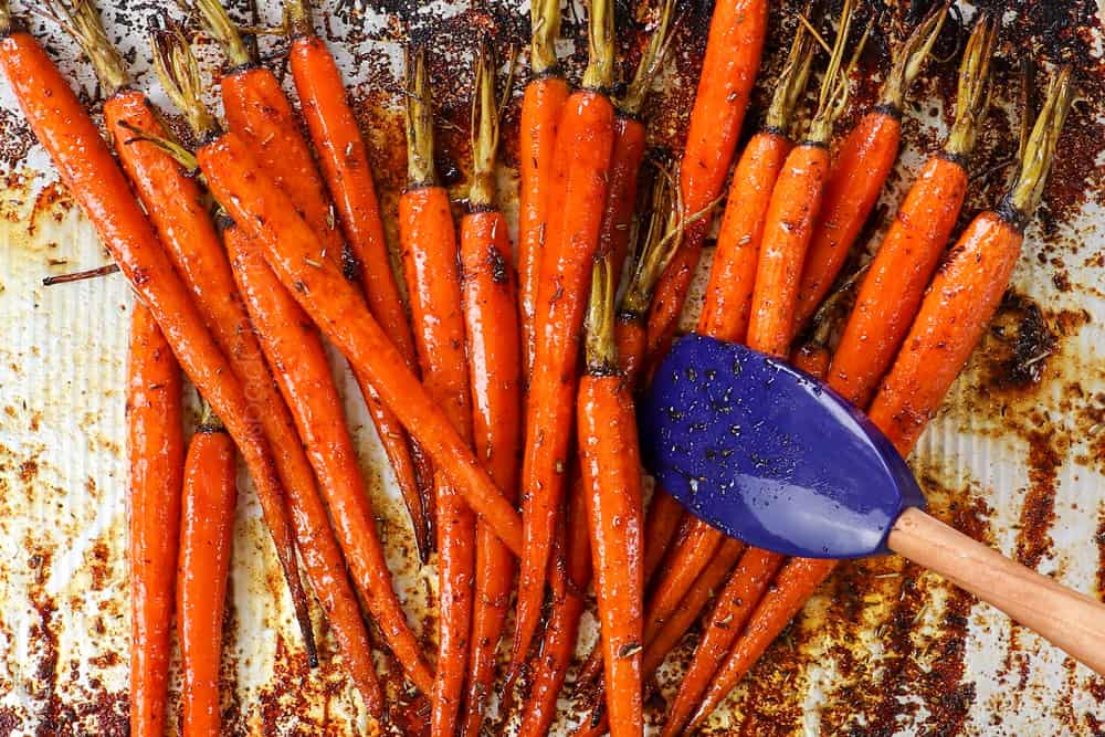 showing how to roast carrots in the oven by cooking until tender then tossing with honey and balsamic