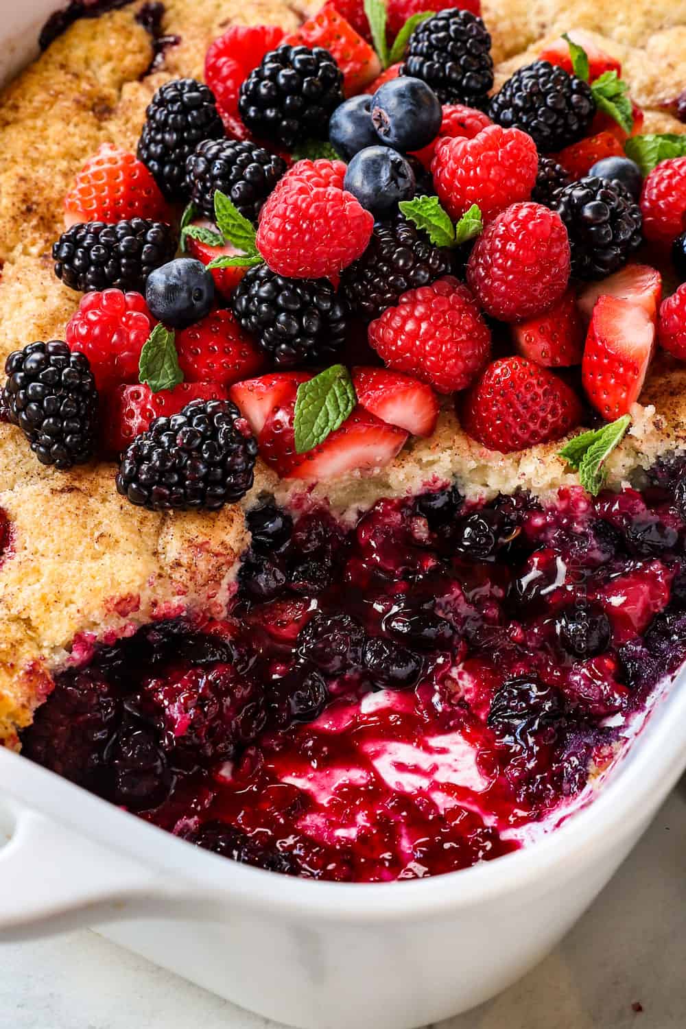 up close of berry cobbler recipe showing the thick, juicy mixed berry filling