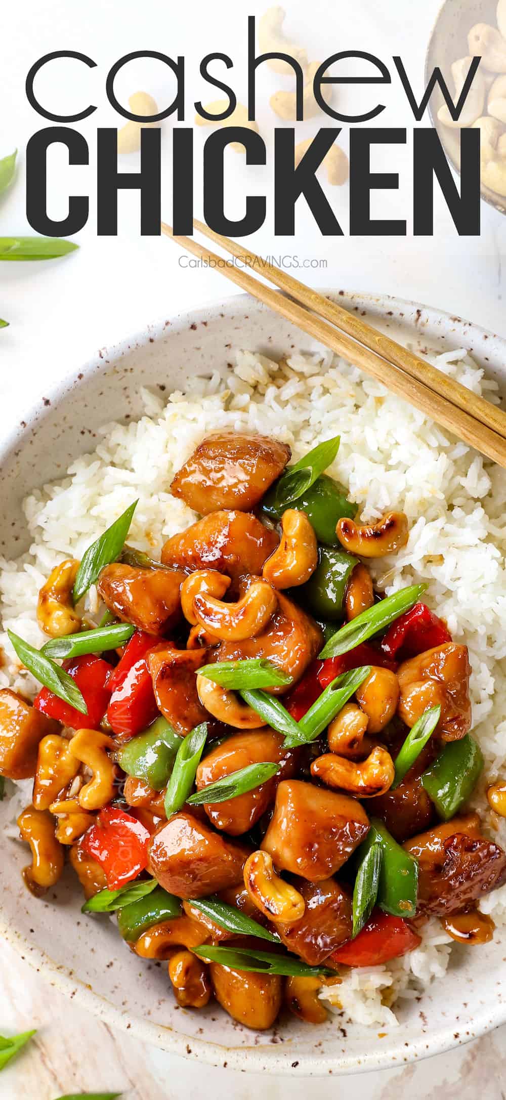 showing how to serve cashew chicken recipe on a white rice garnished with green onions