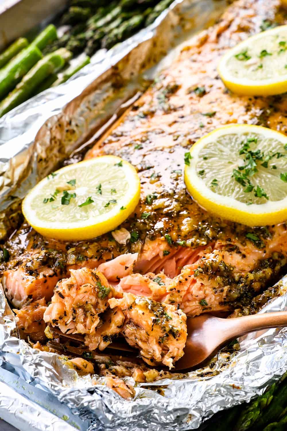 up close of a fork of lemon pepper salmon recipe showing how juicy and tender it is