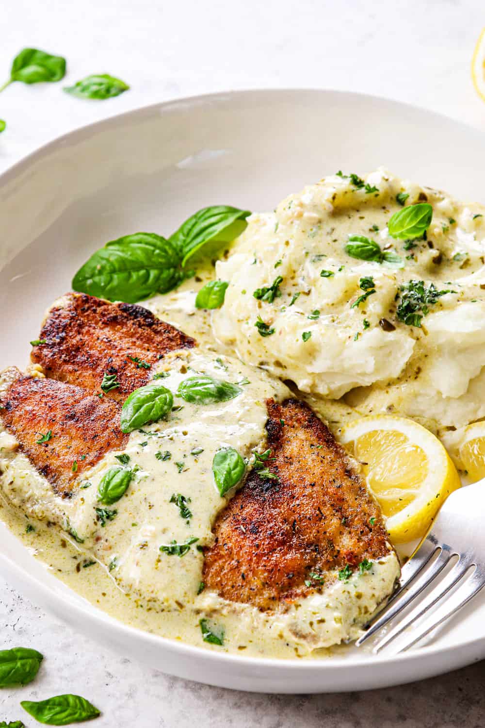 showing how to serve pan fried tilapia recipe with mashed potatoes