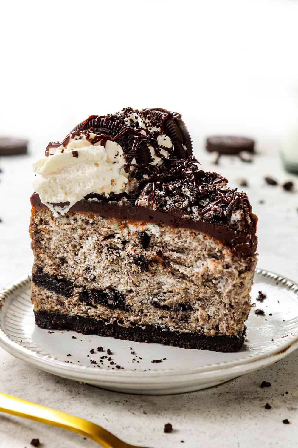 a slice of Oreo cheesecake on a plate showing how creamy it is